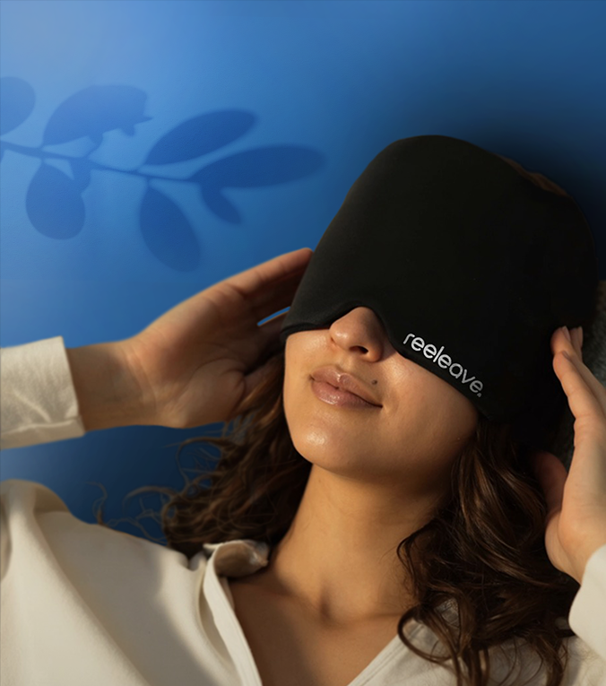 Person wearing a black sleep mask with 'reeleave' branding against a blue background